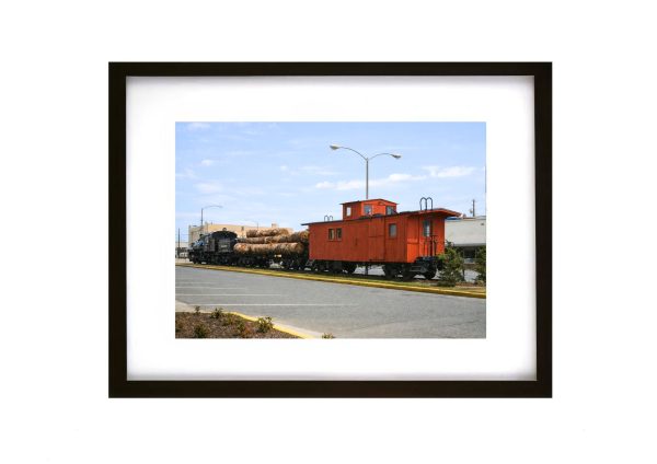 Historic Simpson Logging Railroad train with caboose and timber load